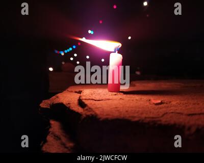 a candal flame is lightning in very dark night Stock Photo