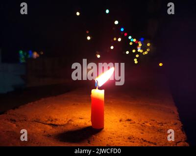 a candal flame is lightning in very dark night Stock Photo