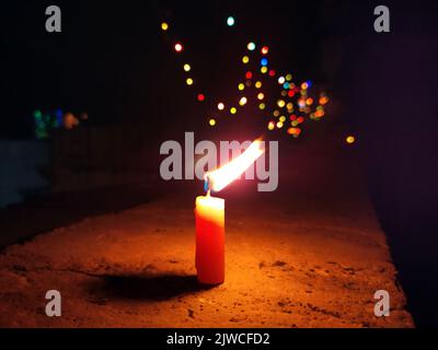 a candal flame is lightning in very dark night Stock Photo