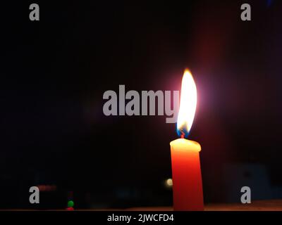 a candal flame is lightning in very dark night Stock Photo