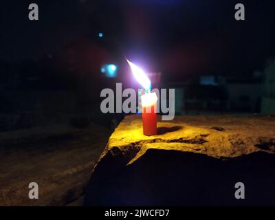 a candal flame is lightning in very dark night Stock Photo