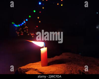a candal flame is lightning in very dark night Stock Photo