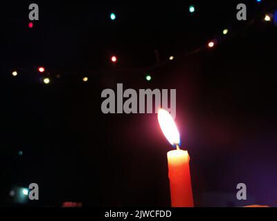 a candal flame is lightning in very dark night Stock Photo