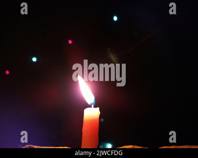 a candal flame is lightning in very dark night Stock Photo
