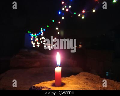 a candal flame is lightning in very dark night Stock Photo
