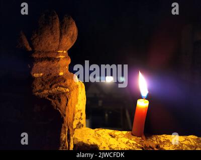 a candal flame is lightning in very dark night Stock Photo