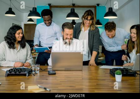 Happy diverse coworkers smiling during business discussion in office Stock Photo