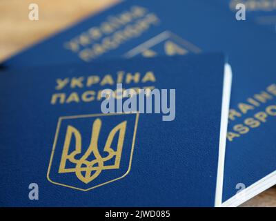 Ukrainian biometric passport id to travel the Europe without visas on the table. Inscription in Ukrainian "Ukraine Passport" Stock Photo