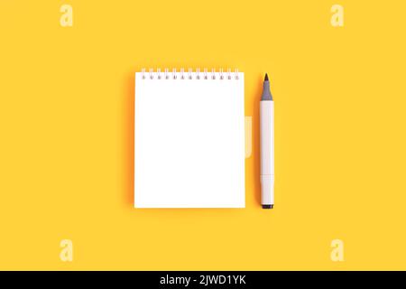 Clean notepad mockup and felt tip pen on a yellow background. Empty notebook template. Stock Photo