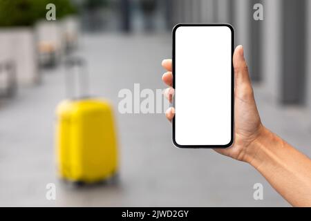 Female hand holding smartphone with white blank screen, mockup Stock Photo