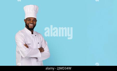 Portrait Of Smiling African American Chef Wearing Uniform Standing With Folded Arms Stock Photo