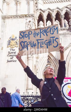 London, England, UK. 5th Sep, 2022. A protester holds a sign which reads ''Stop the racism, stop the flights.'' Pro-refugee protesters gathered outside the Royal Courts Of Justice as a High Court challenge against sending refugees to Rwanda was taking place. (Credit Image: © Vuk Valcic/ZUMA Press Wire) Credit: ZUMA Press, Inc./Alamy Live News Stock Photo