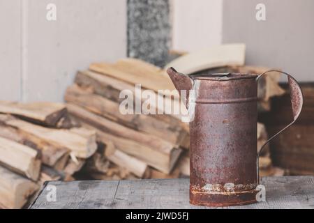 A rusty old dirty cup against pieces of wood. Copy space. Stock Photo