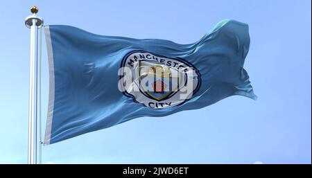 Manchester, UK, May 2022: The flag of Manchester City Football Club waving in the wind. Manchester City is an English football club based in Mancheste Stock Photo