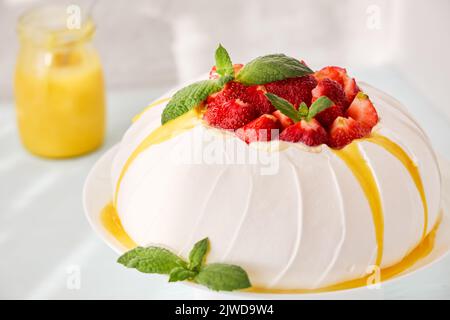 Pavlova cake with strawberries and lemon curd. Close-up. Stock Photo
