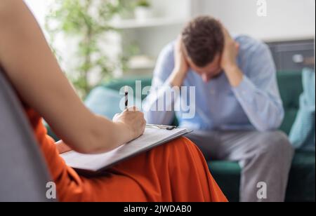 Stressed man at pschologist Stock Photo