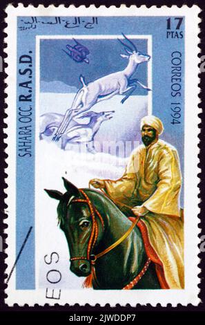 SAHARA - CIRCA 1994: a stamp printed in Sahrawi Arab Democratic Republic shows man and horse, circa 1994 Stock Photo