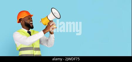 Emotional Black Builder Man Making Announcement With Loudspeaker Over Blue Background Stock Photo