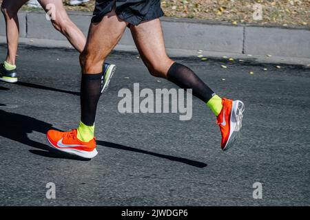 Ekaterinburg, Russia - August 7, 2022: legs male athlete in compression socks running in Europe-Asia Marathon Stock Photo