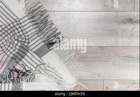 Warm blanket on the background of the laminate. Stock Photo