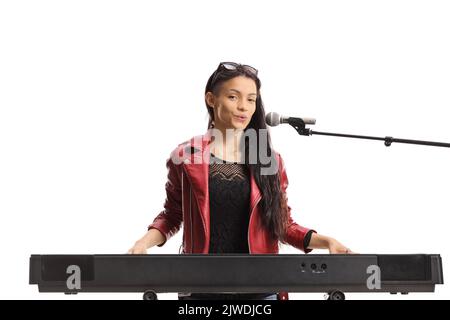 Young female musician playing a keyboard and singing isolated on white background Stock Photo