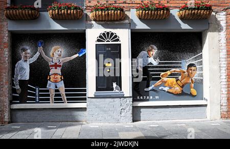 A mural by artist Ciaran Gallagher depicting Liz Truss being declared a winner by Jacob Rees Mogg after beating Rishi Sunak, who is counted out by Boris Johnson, in a boxing match, which has been unveiled in Belfast after Ms Truss won the Conservative party leadership election, becoming the next Prime Minister. Picture date: Monday September 5, 2022. Stock Photo
