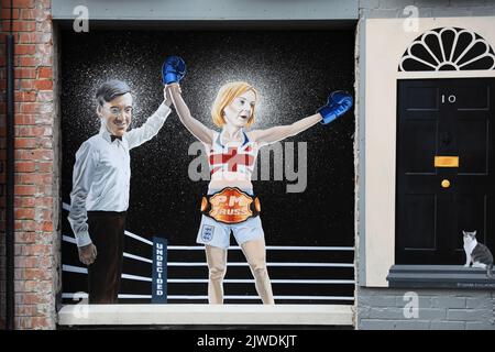 A mural by artist Ciaran Gallagher depicting Liz Truss being declared a winner by Jacob Rees Mogg after beating Rishi Sunak, who is counted out by Boris Johnson, in a boxing match, which has been unveiled in Belfast after Ms Truss won the Conservative party leadership election, becoming the next Prime Minister. Picture date: Monday September 5, 2022. Stock Photo