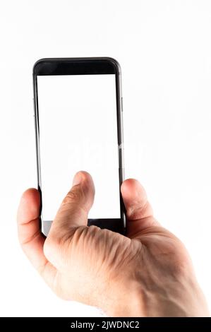 Man hand using smartphone on white background. Closeup shot of man hand holding a smartphone. Vertical image Stock Photo