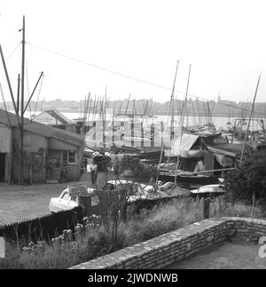 1960, historical, view over Parkstone Yacht Club, Poole, Dorset, England, UK, showing boats and various marine repair sheds, including that of E. Gillam, Marine Engineering, Sales & Service. Located on the North shore of Poole harbour, the second largest natural harbour in the world, the Yacht Club was established in 1895. Stock Photo