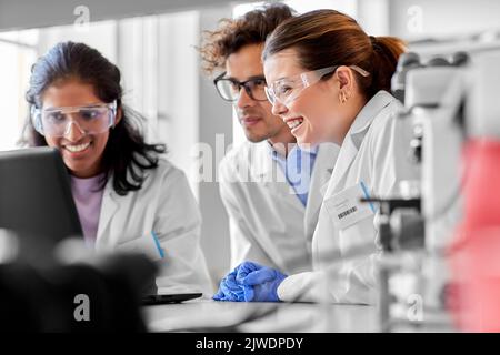 scientists with laptop working in laboratory Stock Photo