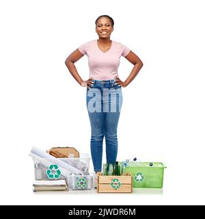 happy woman sorting paper, metal and plastic waste Stock Photo