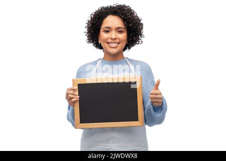 woman in apron with chalkboard showing thumbs up Stock Photo