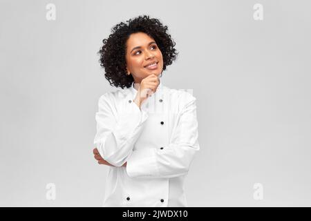 smiling female chef in white jacket Stock Photo