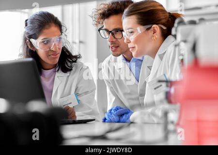 scientists with laptop working in laboratory Stock Photo
