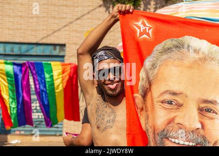 Goiânia, Goias, Brazil – September 05, 2022:  A boy holding a towel with the face of Lula, candidate for president in Brazil. Stock Photo
