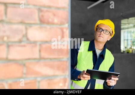 architect in helmet and safety west with tablet pc Stock Photo