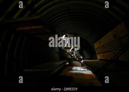 ZAPORIZHZHIA REGION, UKRAINE - SEPTEMBER 02, 2022 - A serviceman gets out of a special metal 'capsules' used for making improvements to the defensive installations, Zaporizhzhia, south-eastern Ukraine. Stock Photo