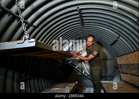 ZAPORIZHZHIA REGION, UKRAINE - SEPTEMBER 02, 2022 - A serviceman shows one of the special metal 'capsules' used for making improvements to the defensive installations, Zaporizhzhia, south-eastern Ukraine. Stock Photo