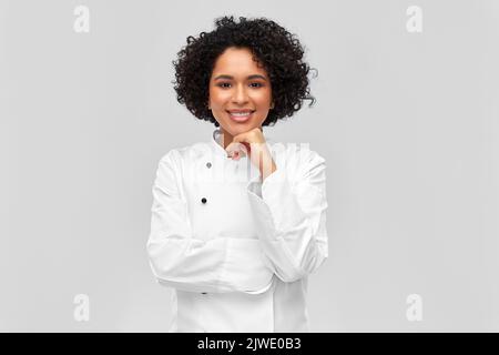smiling female chef in white jacket Stock Photo
