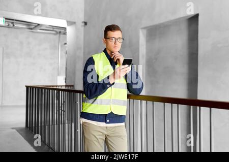 male supervisor with smartphone at office Stock Photo