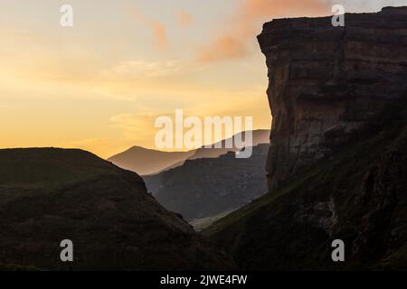 Enchanted Drakensberg sunset, with the silhouette of the Sentinel Buttress of the Golden Gate Highlands National Park, South Africa Stock Photo