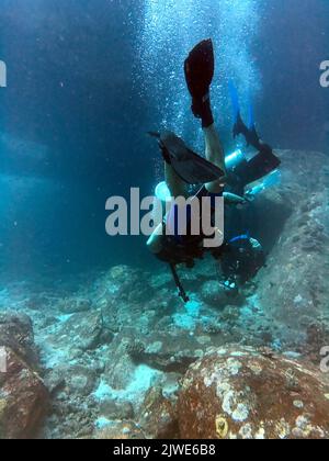 Couple scuba diving in the Mu Ko Similan National Park, Similan Islands, Thailand Stock Photo