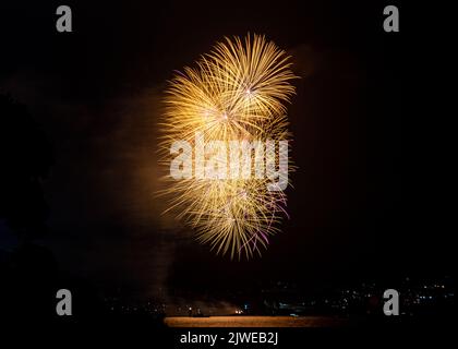 Firework explosions over the harbour from Devil's Point as part of 2022 British firework championships held at Plymouth, Devon.  Display by Wizard Fir Stock Photo