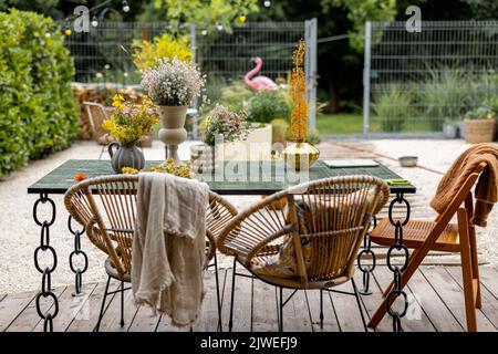 Cozy dining place on wooden terrace at backyard Stock Photo