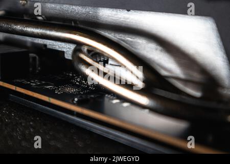 Gpu graphics or video card cooling pipes close-up on black, PC hardware electronics details for gamer or crypto mining, components from powerful compu Stock Photo
