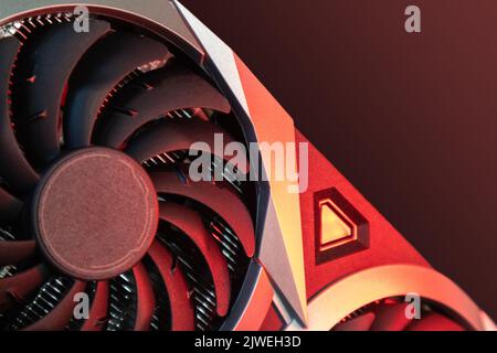 Cooler fan on Gpu graphics video card, close-up in red light, PC hardware details. Components from powerful modern personal computer Stock Photo