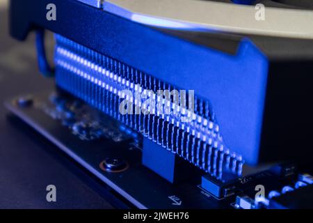 Gpu graphics or video card cooling system close-up in blue light with blur, PC hardware electronics details. Components from powerful computer for gam Stock Photo