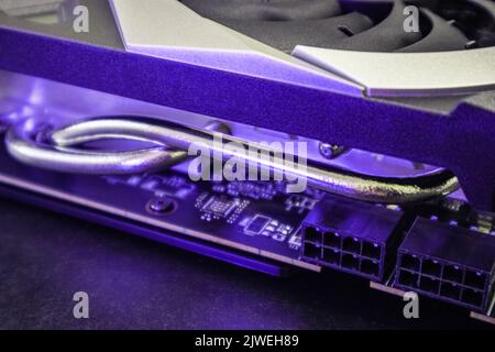 Gpu graphics or video card cooling system close-up in purple light, PC hardware electronics details. Components from powerful computer for gamer or cr Stock Photo