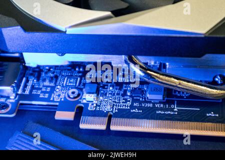Gpu graphics or video card electrical contacts on a chip close-up in blue light, PC hardware electronics details, components from powerful computer Stock Photo