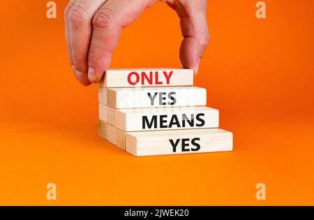 Only yes means yes symbol. Concept words Only yes means yes on wooden blocks on a beautiful orange table orange background. Businessman hand. Business Stock Photo